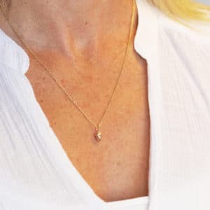 Gold acorn necklace worn