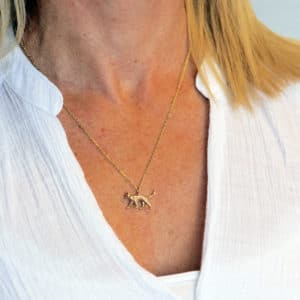 Gold cat necklace worn