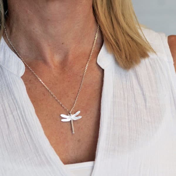 Silver dragonfly necklace worn