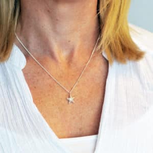 Silver starfish necklace worn