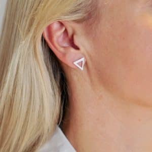 Silver triangle earrings worn