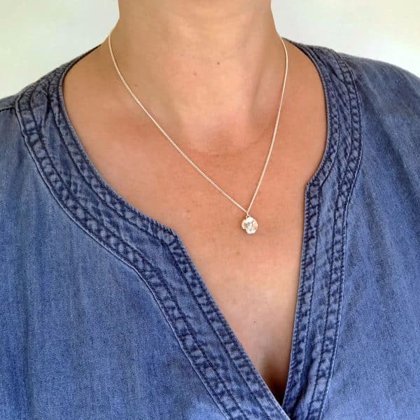 Silver poppy necklace worn