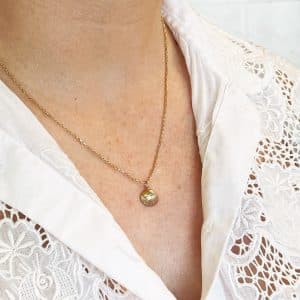 Gold shell necklace worn