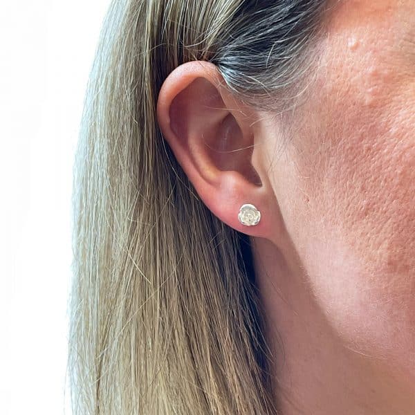 Silver rose earrings worn