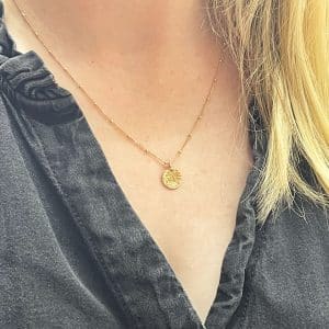 Gold disc necklace worn