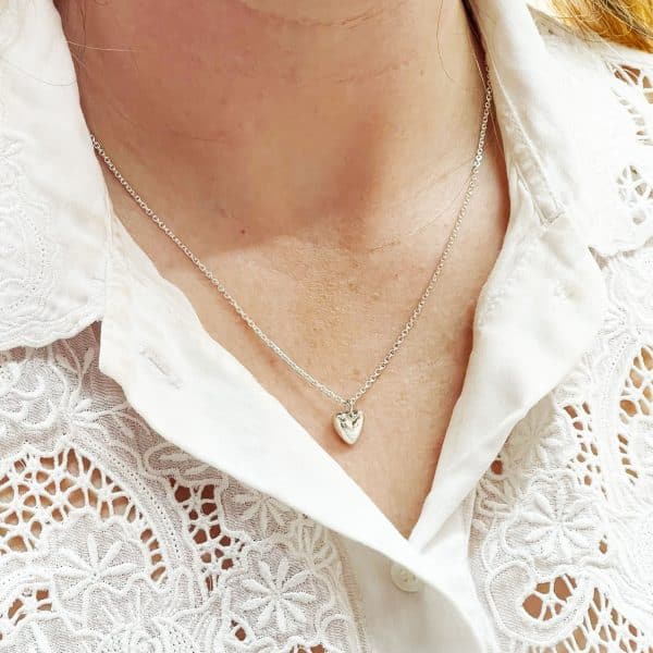 Silver heart necklace worn