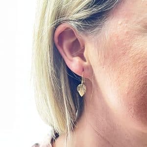 gold leaf hook earrings worn