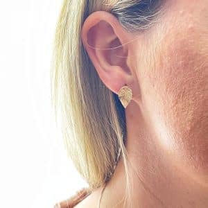 Gold leaf stud earrings worn