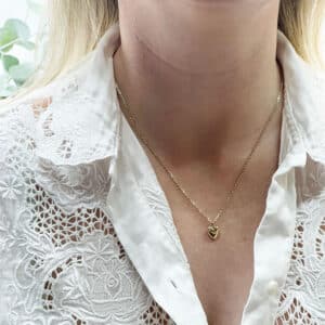 Gold heart necklace worn